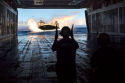 USA Sailor directs a landing craft air cushion into the well deck of the USS Peleliu.png