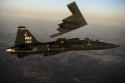 A T-38 Talon flies in formation with  B-2  during a training mission over Whiteman Air F….jpg