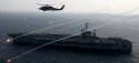 USA Sea Hawk launches flares alongside the aircraft carrier USS John C. Stennis.jpg