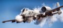 USAF A-10 warthog is covered in smoke as it fires its 30mm anti-tank cannon.jpg