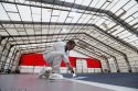 An_employee_inspects_a_painted_section_of_the_flight_deck.jpg An_employee_inspects_a_painted_section_of_the_flight_deck.jpg