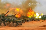 A line of vehicle-mounted howitzers attached to a combined-arms brigade with the army under PL...jpg
